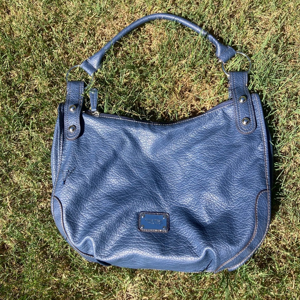 Nine West blue bag with circle details on strap and textured pattern